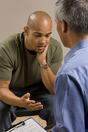 Man talking to health care provider.